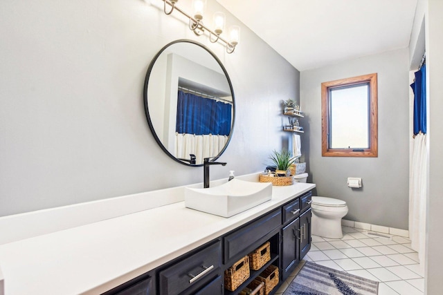 bathroom featuring tile patterned floors, toilet, and vanity