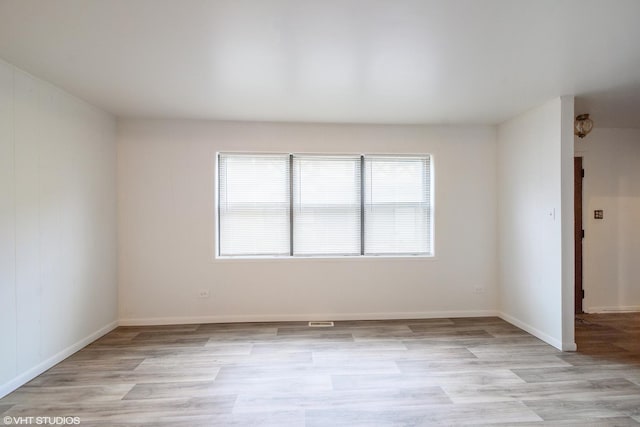 spare room with light hardwood / wood-style floors