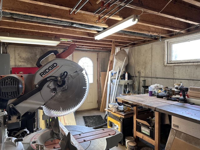 basement featuring a wealth of natural light and a workshop area