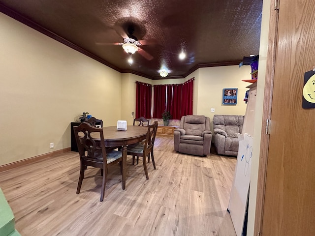 dining room featuring a textured ceiling, light hardwood / wood-style flooring, ornamental molding, and ceiling fan