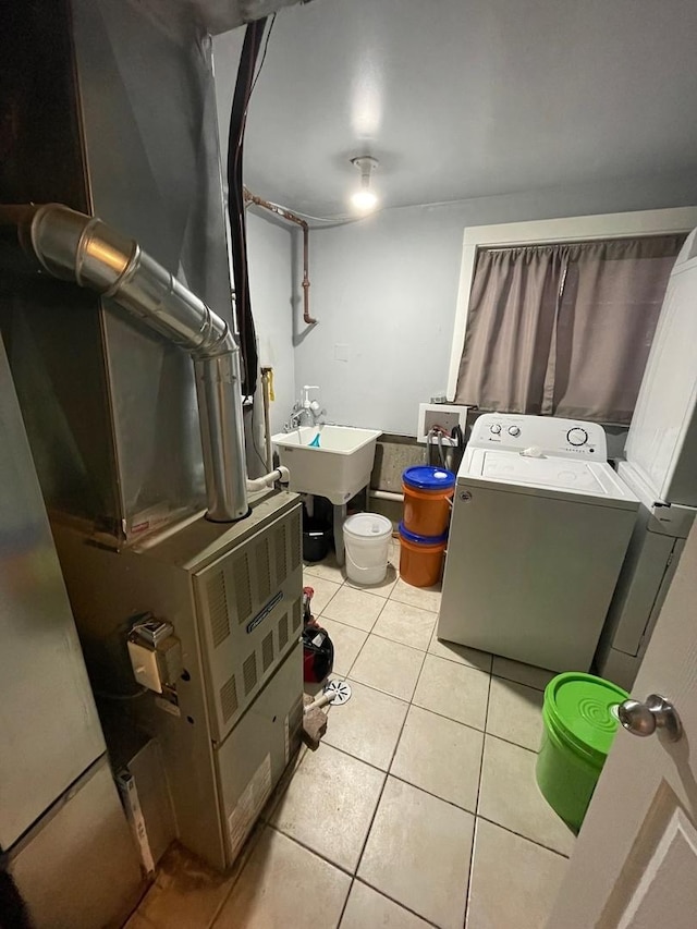 bathroom featuring sink, tile patterned flooring, and heating unit