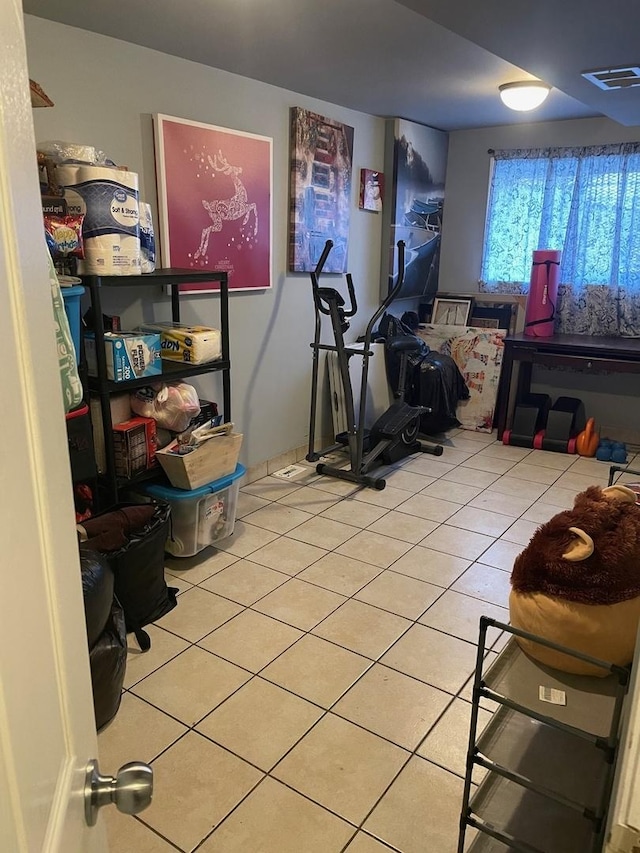 exercise room with light tile patterned floors