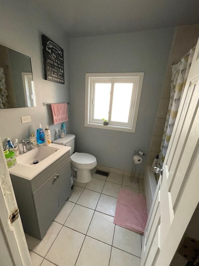 full bathroom featuring vanity, tile patterned floors, shower / bath combo with shower curtain, and toilet