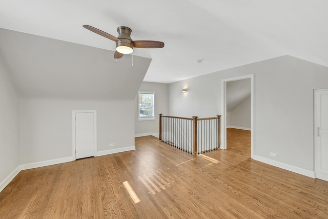 additional living space featuring ceiling fan, lofted ceiling, and light wood-type flooring