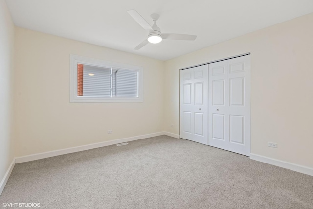 unfurnished bedroom featuring ceiling fan, carpet floors, and a closet