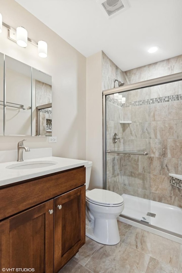 bathroom featuring walk in shower, vanity, and toilet