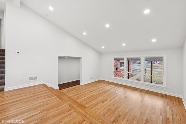 unfurnished living room with high vaulted ceiling and light hardwood / wood-style flooring