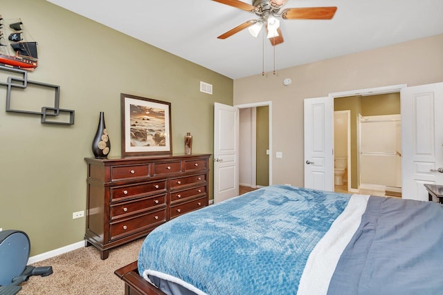 bedroom with light carpet, ceiling fan, and ensuite bathroom