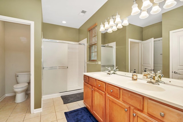 bathroom featuring an enclosed shower, vanity, tile patterned flooring, and toilet