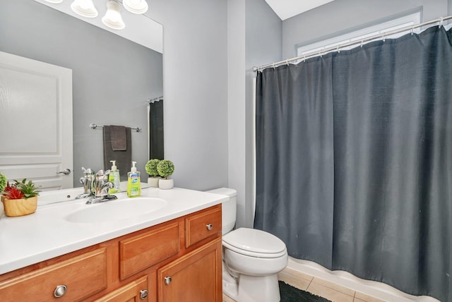 bathroom featuring a shower with curtain, vanity, toilet, and tile patterned flooring