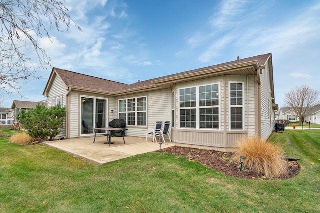 rear view of property with a patio area and a lawn