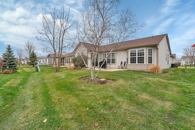 back of property featuring a patio and a yard