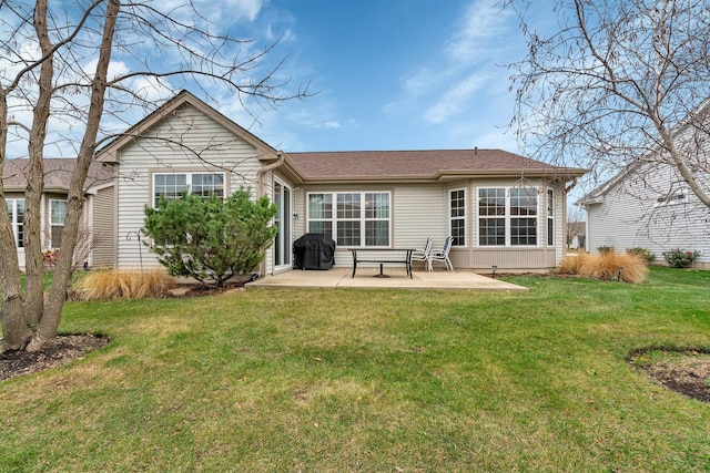 rear view of house with a yard and a patio