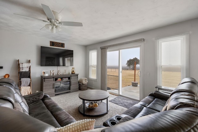 living room with light colored carpet and ceiling fan