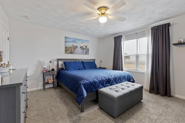 bedroom featuring light colored carpet, a textured ceiling, and ceiling fan