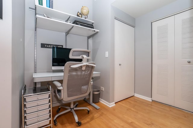 home office with light wood finished floors and baseboards