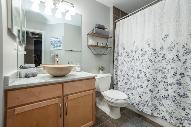 full bathroom featuring toilet, vanity, and tile patterned floors