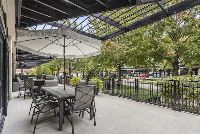 view of patio with outdoor dining space, fence, and a pergola