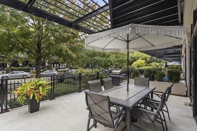 view of patio with outdoor dining space, grilling area, and a pergola