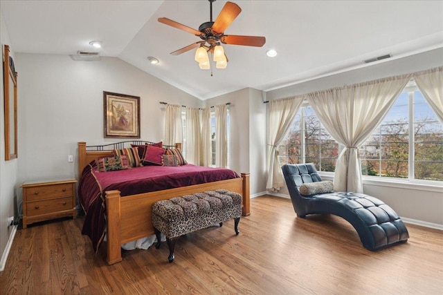 bedroom with wood-type flooring, ceiling fan, and vaulted ceiling