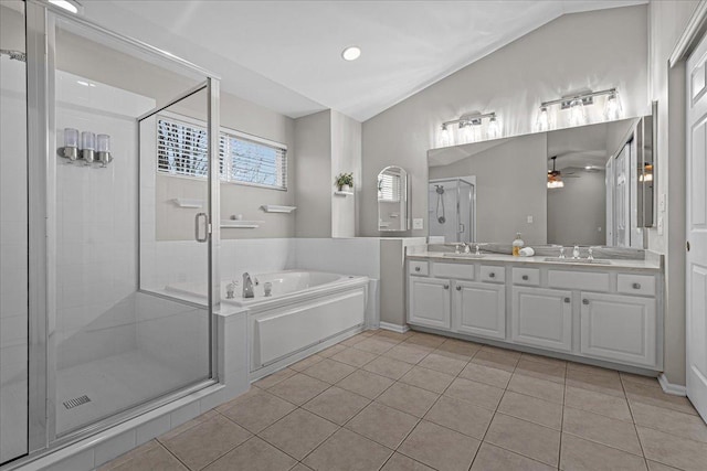 bathroom featuring tile patterned flooring, shower with separate bathtub, and vanity