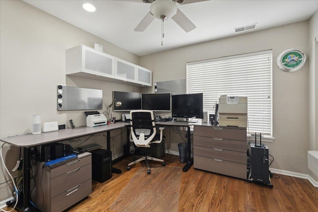 home office featuring dark hardwood / wood-style floors and ceiling fan