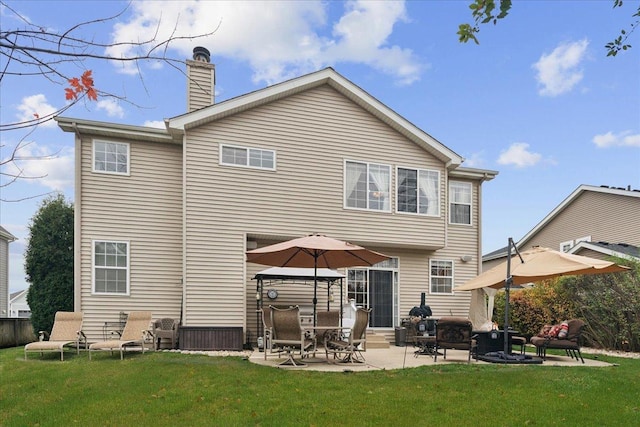 back of house featuring a yard and a patio area