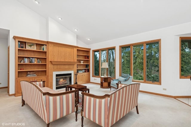 carpeted living room with high vaulted ceiling