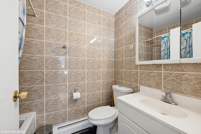 bathroom with baseboard heating, vanity, toilet, and tile walls