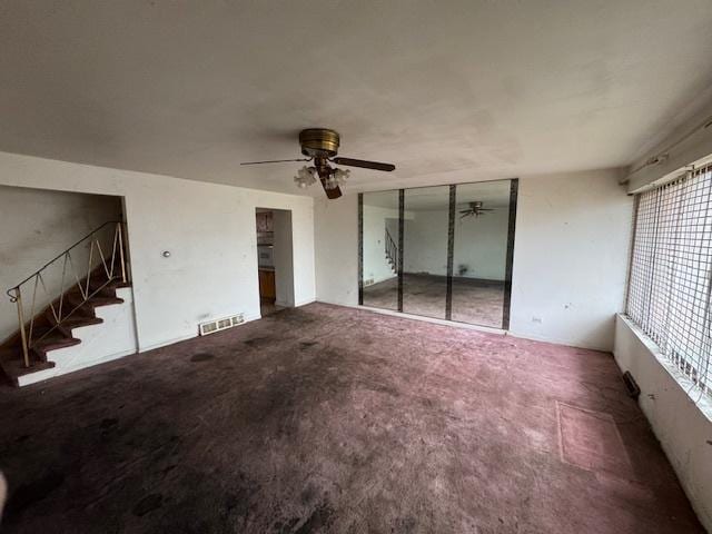 interior space with ceiling fan and carpet