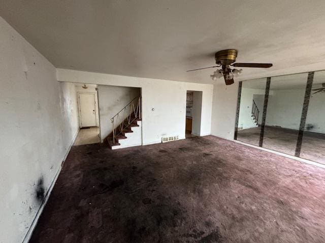 unfurnished living room with ceiling fan