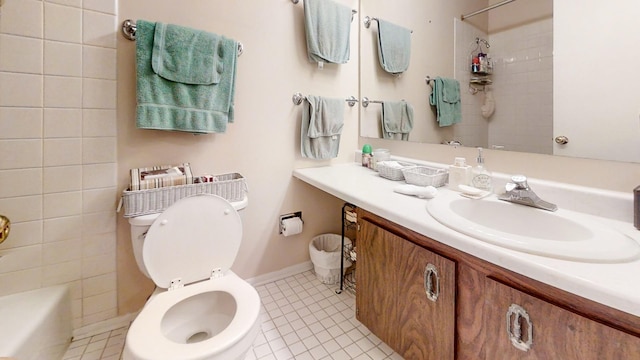 full bathroom featuring tile patterned flooring, vanity, tiled shower / bath combo, and toilet