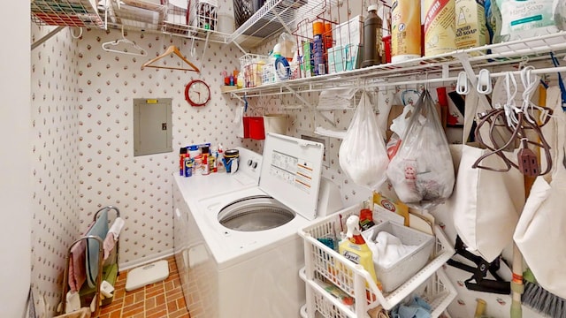 washroom with washing machine and clothes dryer and electric panel