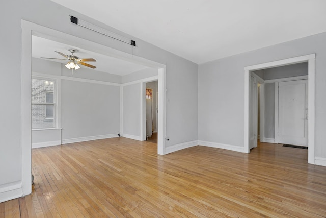 empty room with ceiling fan and light wood-type flooring