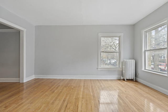 empty room with radiator and light hardwood / wood-style floors