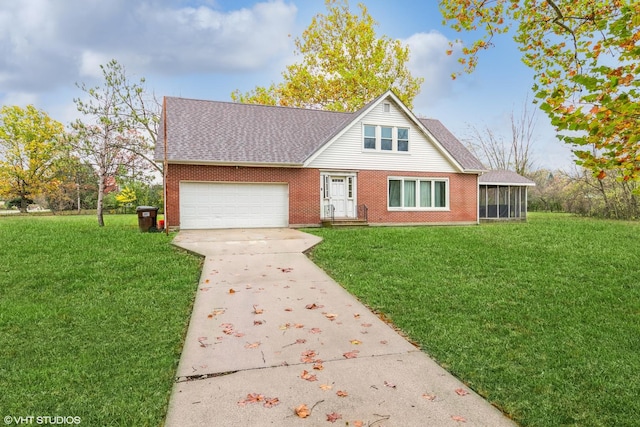 view of front of house with a garage, a sunroom, and a front lawn