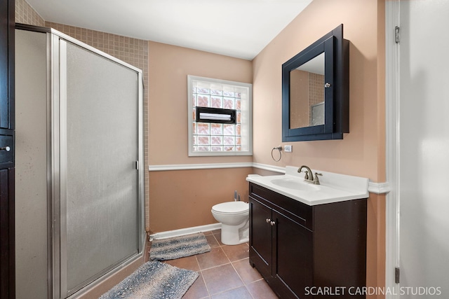 bathroom with vanity, toilet, an enclosed shower, and tile patterned flooring