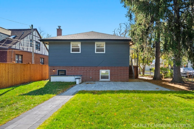 rear view of property featuring a yard and a patio