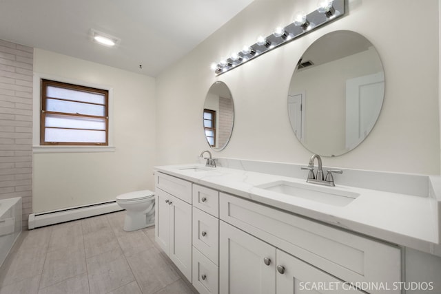 bathroom with vanity, a baseboard heating unit, a tub, and toilet