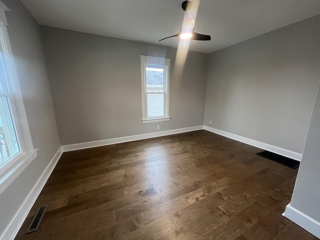 spare room featuring dark hardwood / wood-style floors and ceiling fan