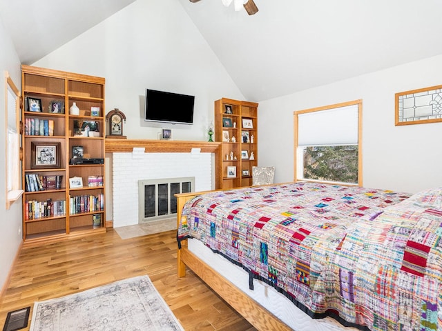 37W751 Orchard Ln, Elgin, IL 60124 - bedroom featuring high vaulted ceiling, a brick fireplace, wood finished floors, and visible vents