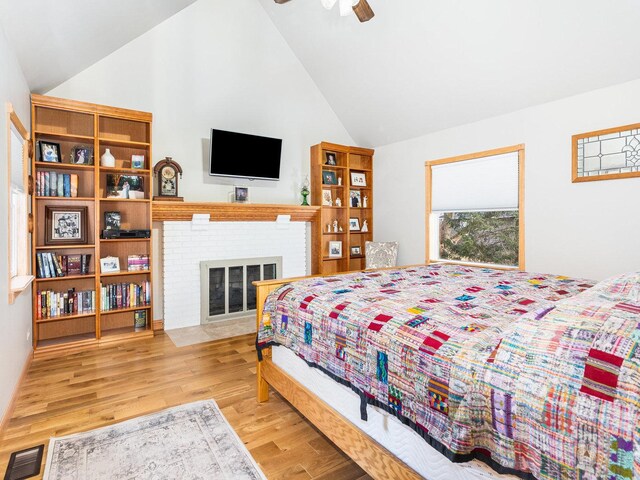 37W751 Orchard Ln, Elgin, IL 60124 - bedroom featuring wood finished floors, high vaulted ceiling, and a fireplace