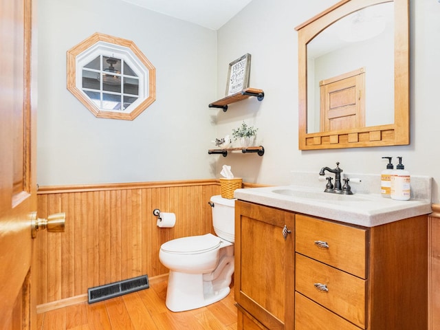 37W751 Orchard Ln, Elgin, IL 60124 - half bathroom featuring visible vents, wainscoting, toilet, wood finished floors, and vanity