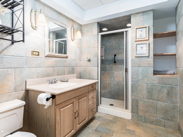 37W751 Orchard Ln, Elgin, IL 60124 - full bathroom with stone tile floors, toilet, vanity, a shower stall, and tile walls