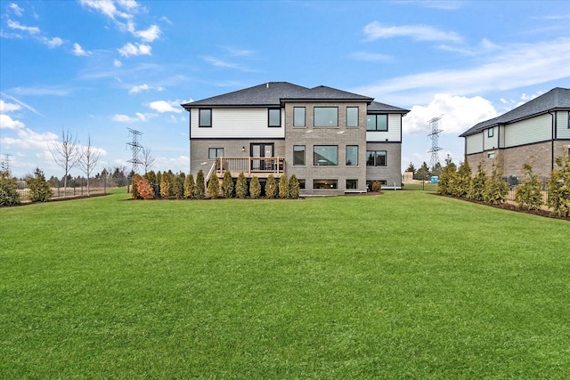 rear view of house featuring a lawn