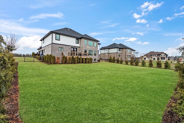 rear view of property with a yard