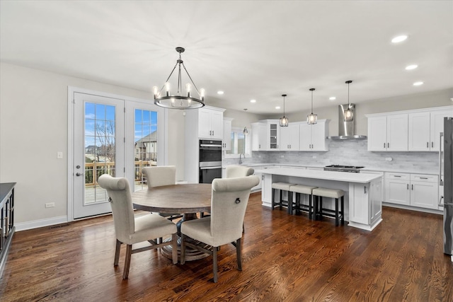 dining room featuring an inviting chandelier, sink, and dark wood-type flooring