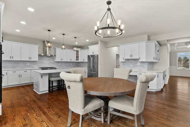 dining space featuring dark hardwood / wood-style flooring and a notable chandelier