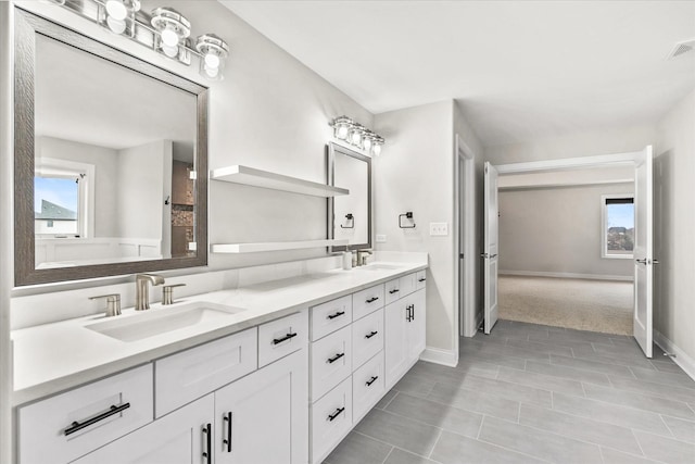 bathroom with vanity, tile patterned floors, and a healthy amount of sunlight