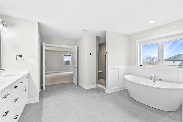 bathroom featuring vanity, shower with separate bathtub, a wealth of natural light, and tile patterned floors